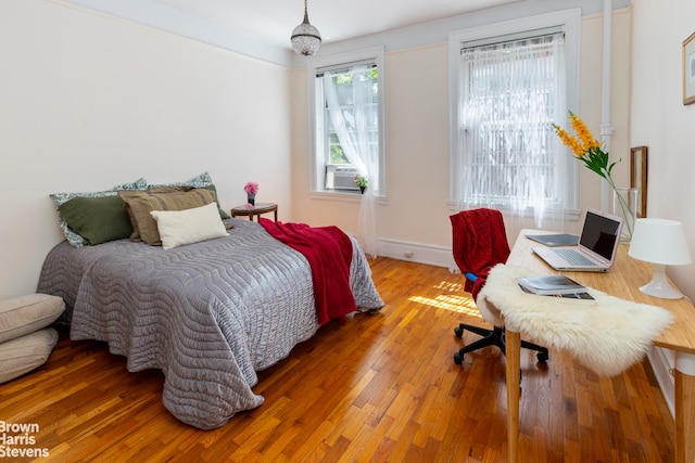 bedroom with hardwood / wood-style flooring