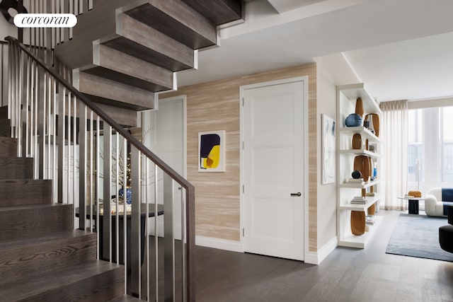35 Hudson Yards Unit 7302, New York City, NY 10001 - stairway with baseboards, wood finished floors, and wooden walls