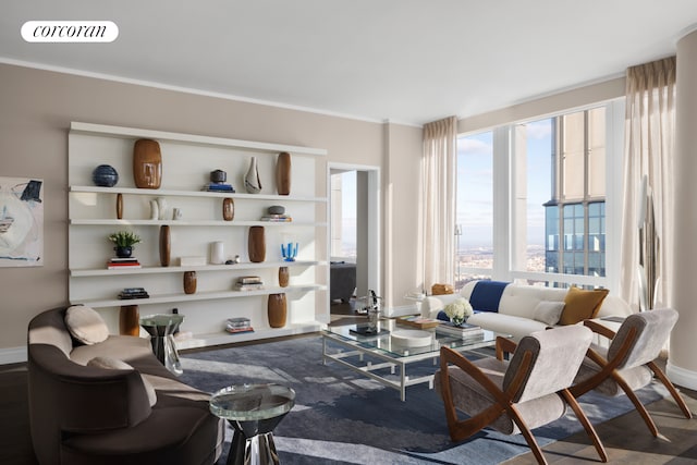 living room featuring visible vents, baseboards, and wood finished floors