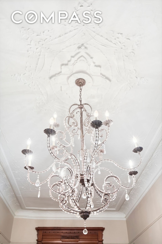 details featuring a chandelier and ornamental molding