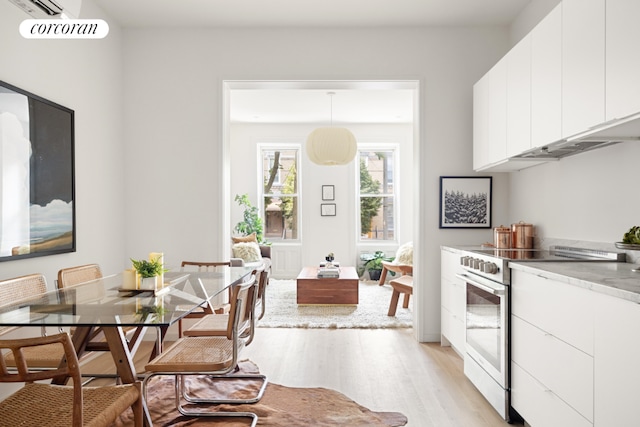 dining area featuring light wood-type flooring