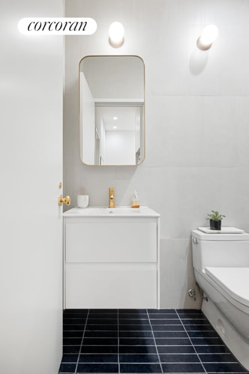 bathroom with vanity and toilet