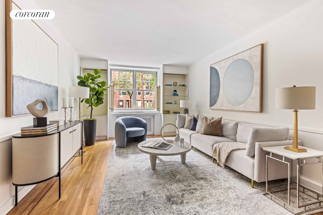 living area featuring light wood-style floors and visible vents