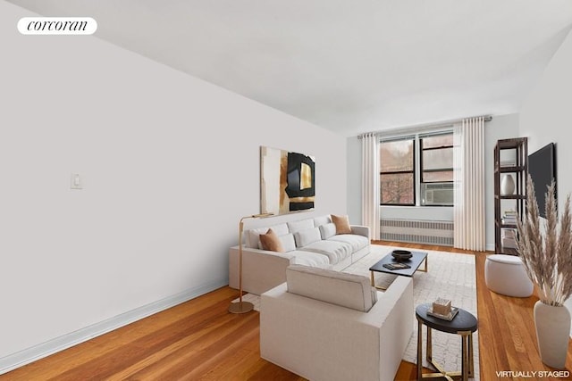 living room with wood-type flooring and radiator heating unit