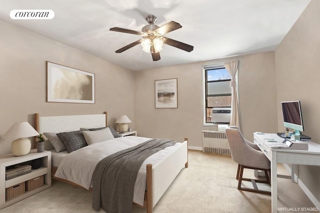 carpeted bedroom with radiator heating unit and ceiling fan