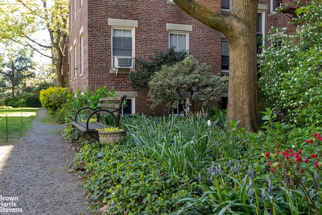 view of side of property with cooling unit and brick siding