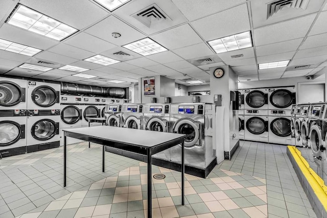 washroom featuring light tile patterned floors, washing machine and dryer, and stacked washer / dryer