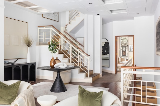 interior space featuring stairway, wood finished floors, and baseboards