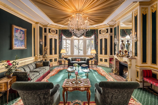 sitting room featuring a tray ceiling, ornamental molding, a high end fireplace, and an inviting chandelier