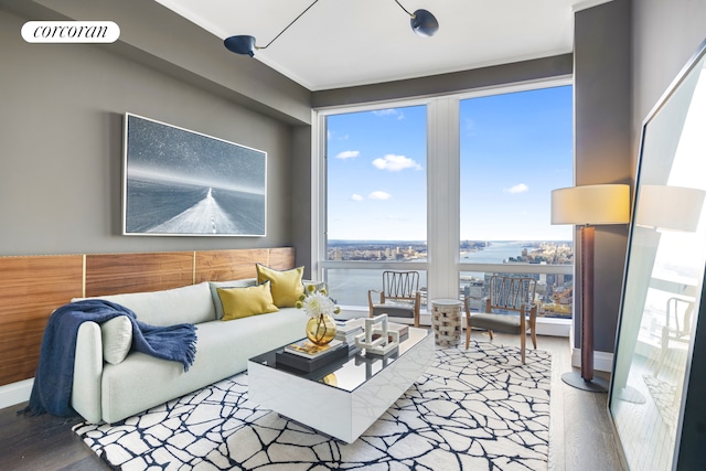 35 Hudson Yards Unit 8302, New York City, NY 10001 - living room featuring wood finished floors, healthy amount of natural light, and a water view