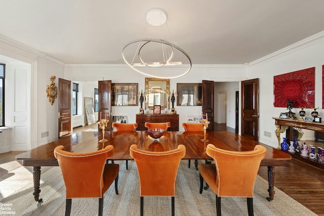 dining area featuring crown molding and hardwood / wood-style flooring