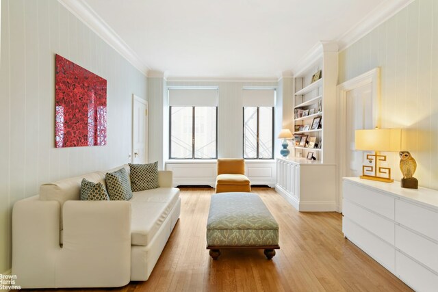 bedroom featuring light carpet and crown molding