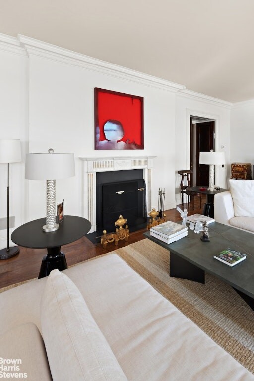 bedroom with hardwood / wood-style floors and crown molding