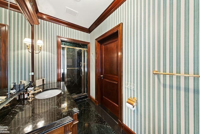 bathroom featuring sink, a shower with door, and ornamental molding