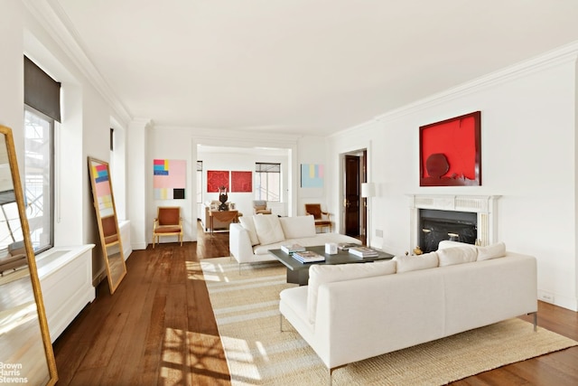 living room with built in features, crown molding, and light wood-type flooring