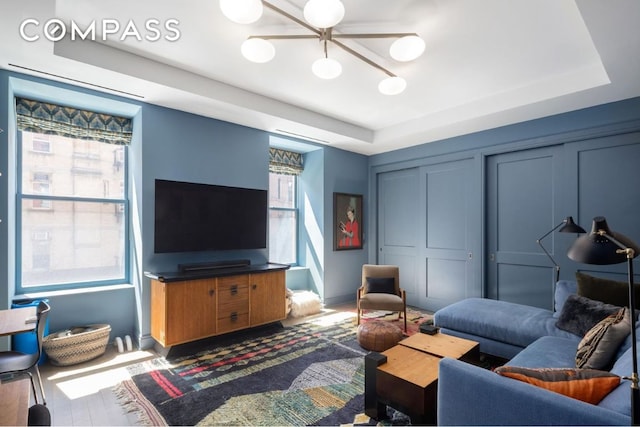 living room featuring a tray ceiling