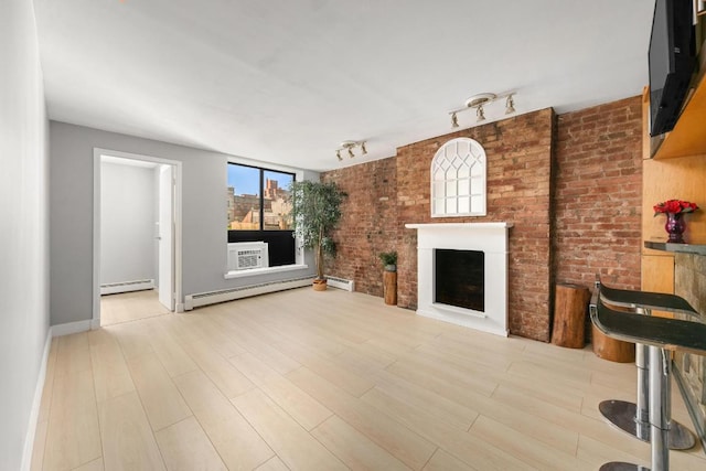 unfurnished living room with baseboard heating and light wood-type flooring