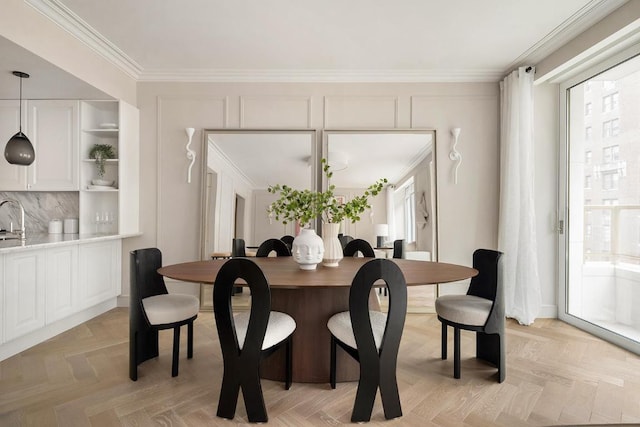 dining room featuring ornamental molding, light parquet flooring, and plenty of natural light