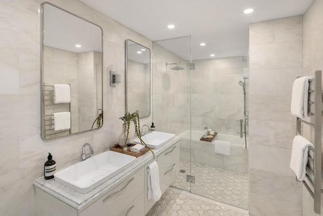 bathroom featuring vanity, tile walls, and a shower with shower door