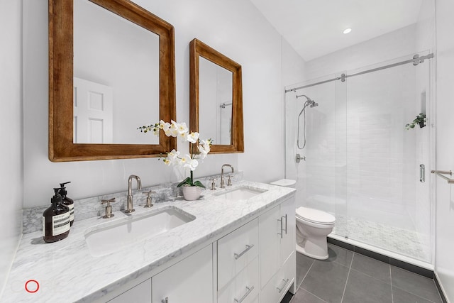 full bath with a sink, a shower stall, and tile patterned floors