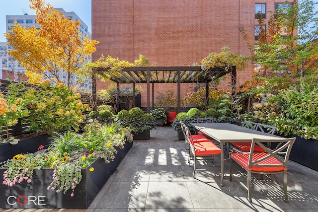 view of patio / terrace with a garden, outdoor dining area, and a pergola