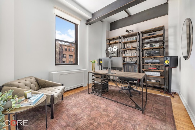 home office featuring baseboards and wood finished floors