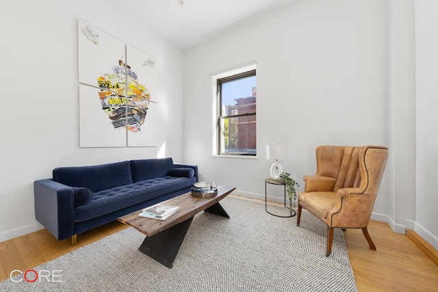 living room featuring light wood-type flooring and baseboards