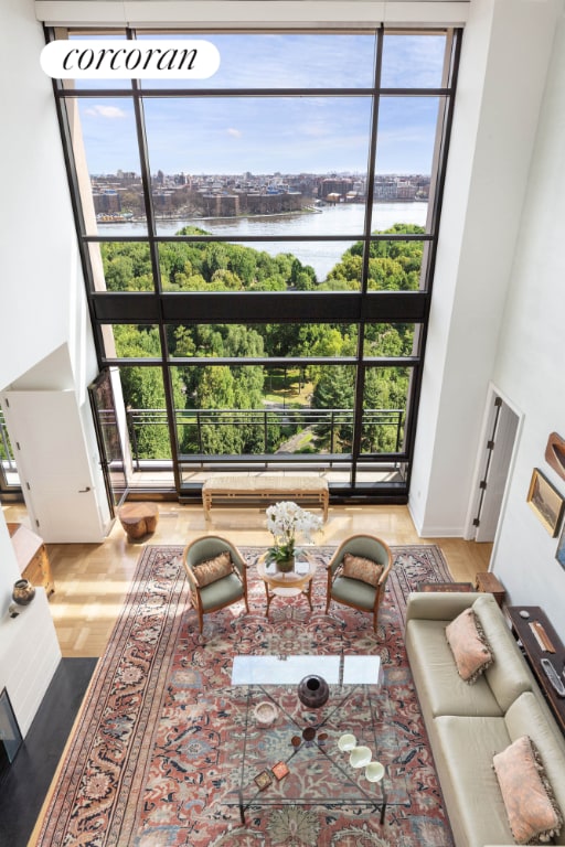 living room featuring a water view and hardwood / wood-style flooring