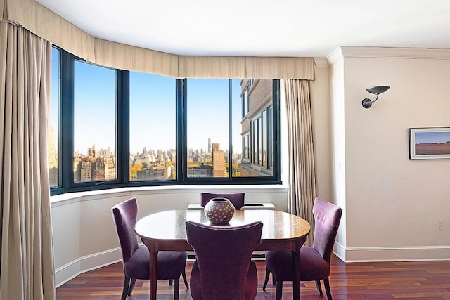 dining space with crown molding and dark hardwood / wood-style floors