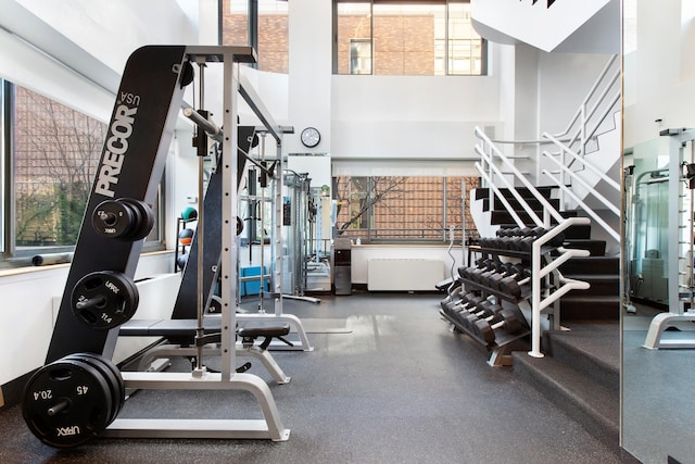 workout area with a high ceiling