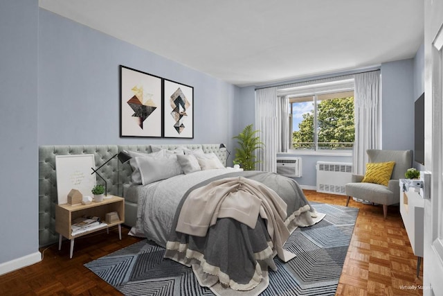 bedroom with parquet flooring, radiator heating unit, and cooling unit