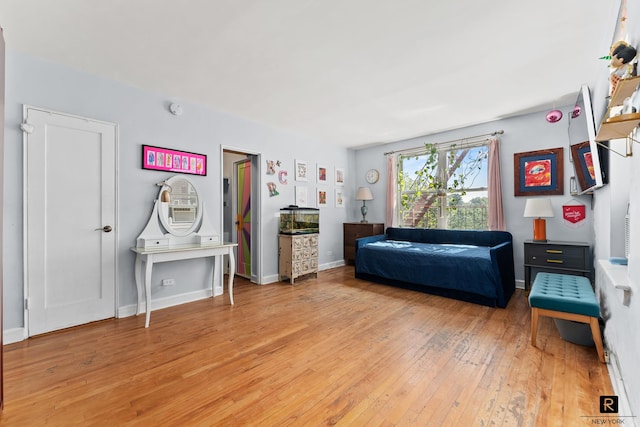 bedroom featuring wood finished floors and baseboards