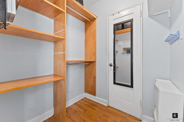spacious closet with wood finished floors