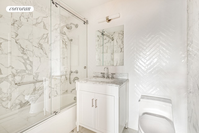 bathroom featuring combined bath / shower with glass door, vanity, and toilet