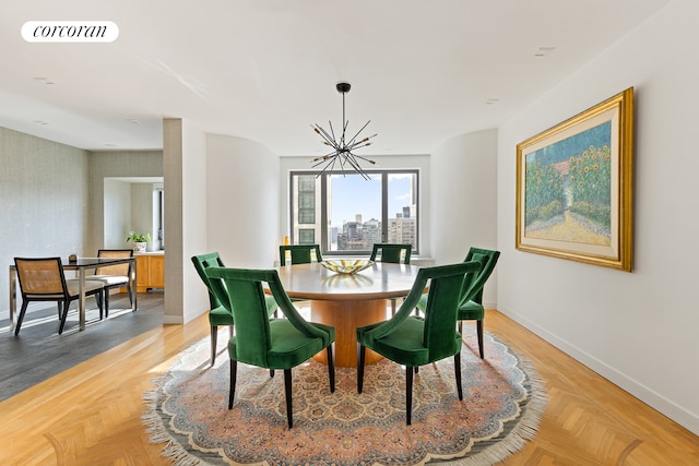 dining space featuring a chandelier, a city view, visible vents, and baseboards