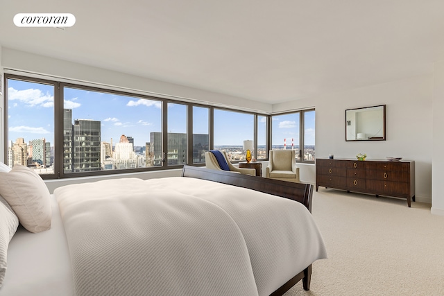 bedroom featuring visible vents, a city view, and light colored carpet