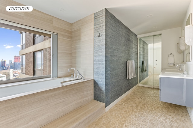 bathroom with visible vents, vanity, and a bath