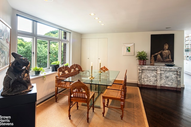 dining room with baseboards, wood finished floors, and recessed lighting