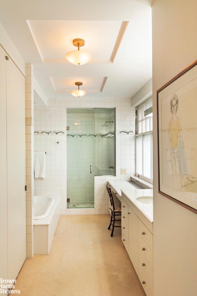 full bathroom featuring tile walls, a stall shower, vanity, a bath, and tile patterned floors