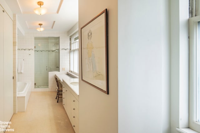 full bath featuring a stall shower, a garden tub, and vanity