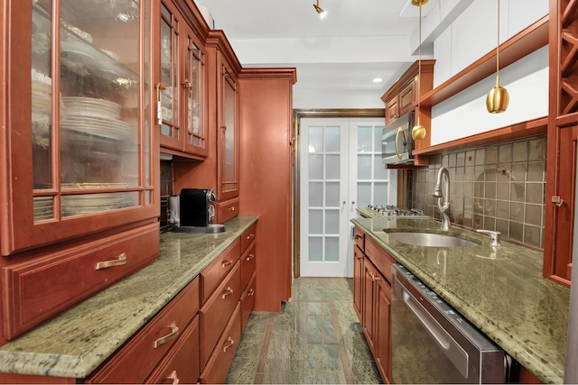 155 E 49th St Unit 9F, New York City, NY 10017 - kitchen with appliances with stainless steel finishes, a sink, light stone counters, pendant lighting, and backsplash