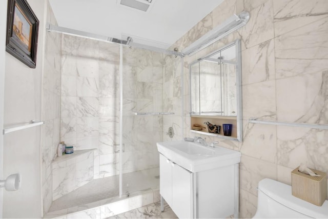 bathroom with a shower with shower door, tile walls, toilet, and vanity