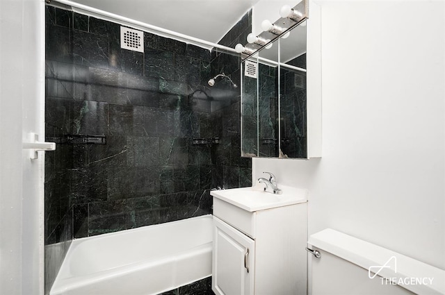 bathroom featuring toilet,  shower combination, and vanity