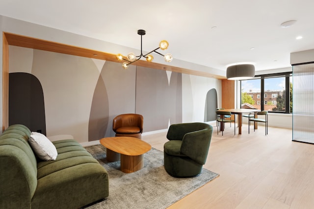 living room with a chandelier and light hardwood / wood-style floors