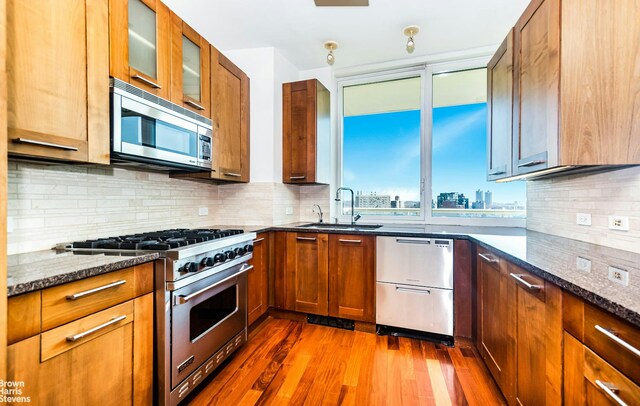 spare room featuring radiator heating unit and hardwood / wood-style floors