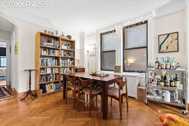 dining area with light parquet flooring and crown molding