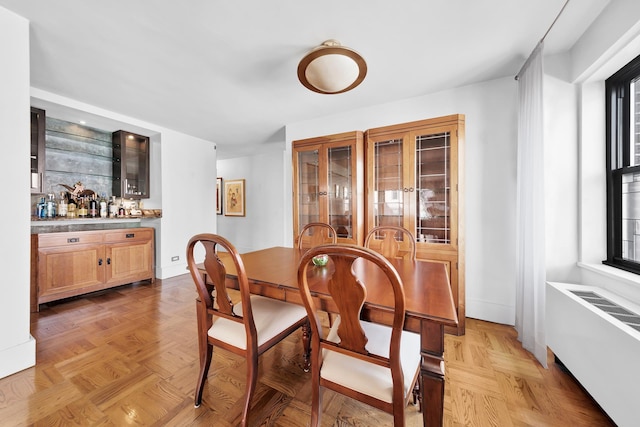 dining area featuring radiator and a bar