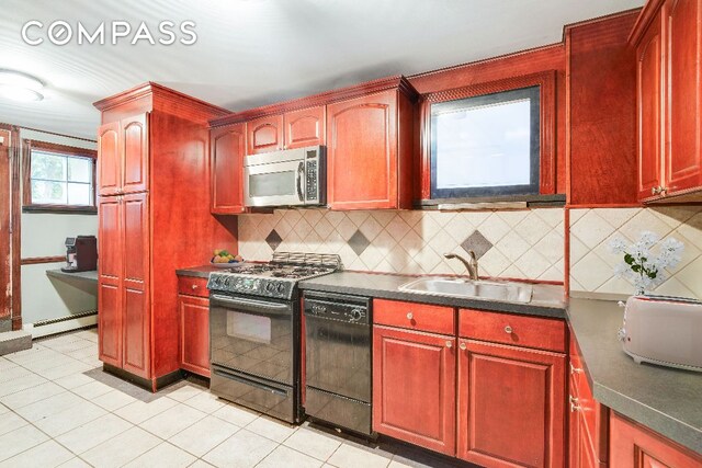 kitchen with tasteful backsplash, sink, white appliances, and dark tile patterned floors