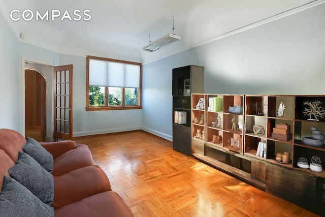 living area with ornamental molding and baseboards