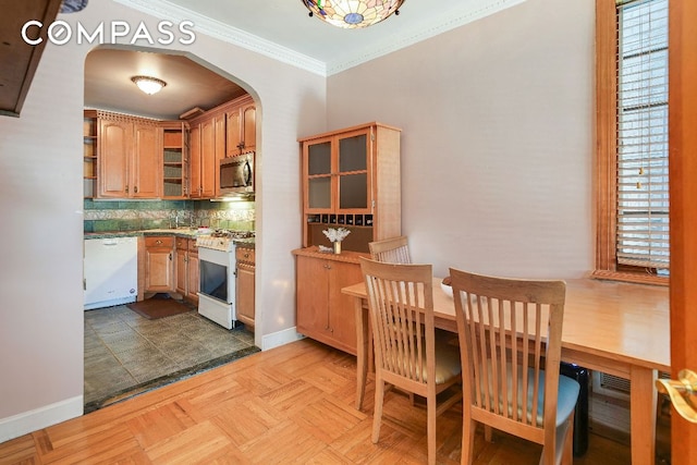 kitchen featuring crown molding, open shelves, decorative backsplash, glass insert cabinets, and white appliances